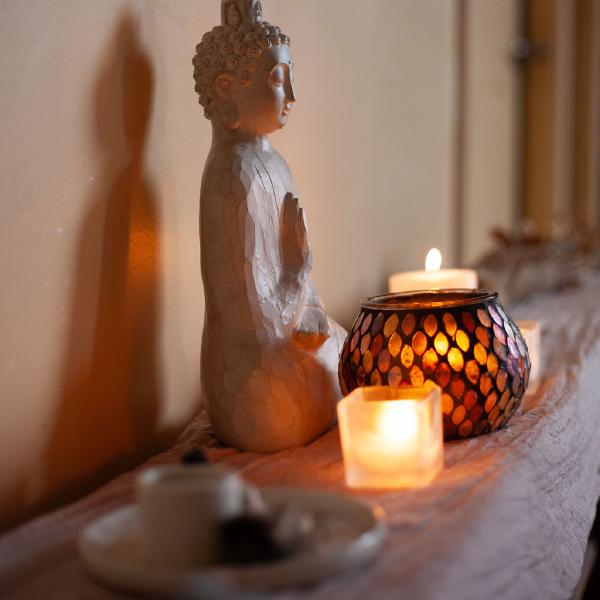 candles and buddha on alter