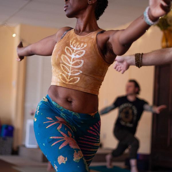 woman balancing on yoga mat