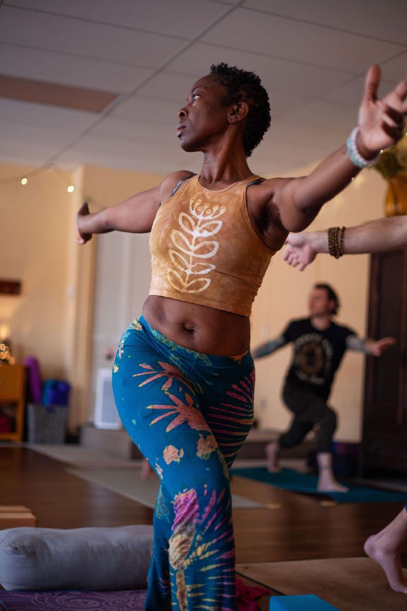 woman balancing on yoga mat