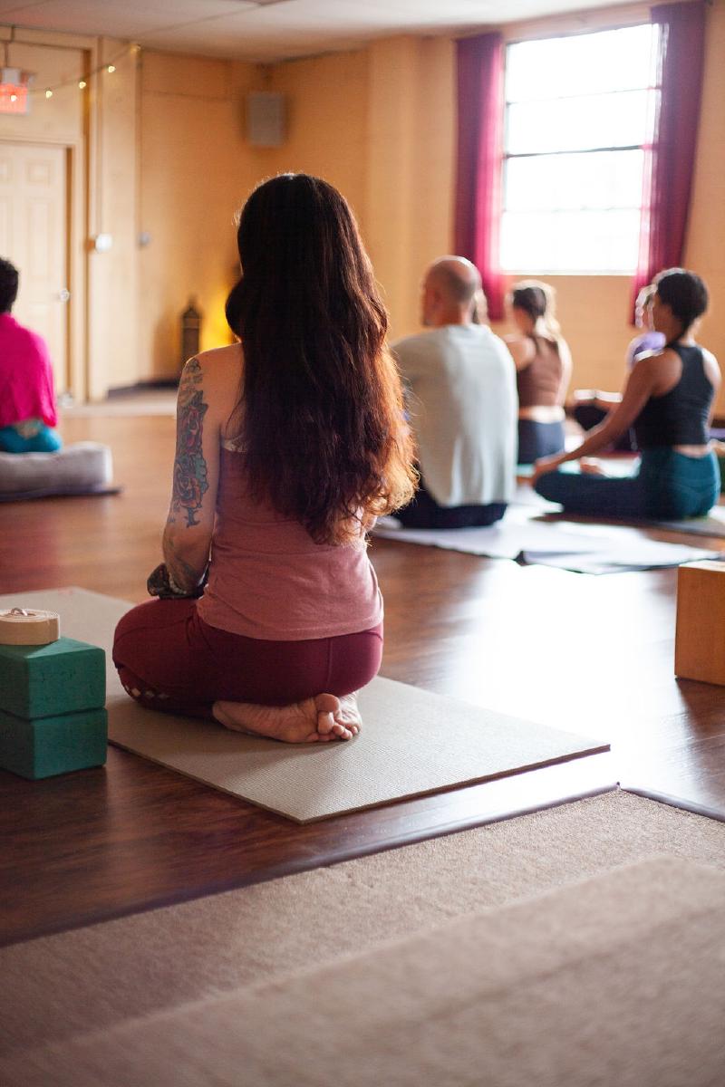 woman looking up from yoga mat