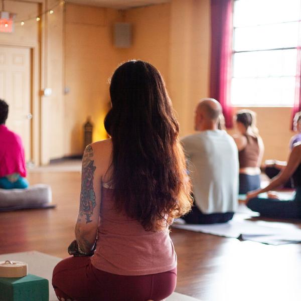 woman looking up from yoga mat