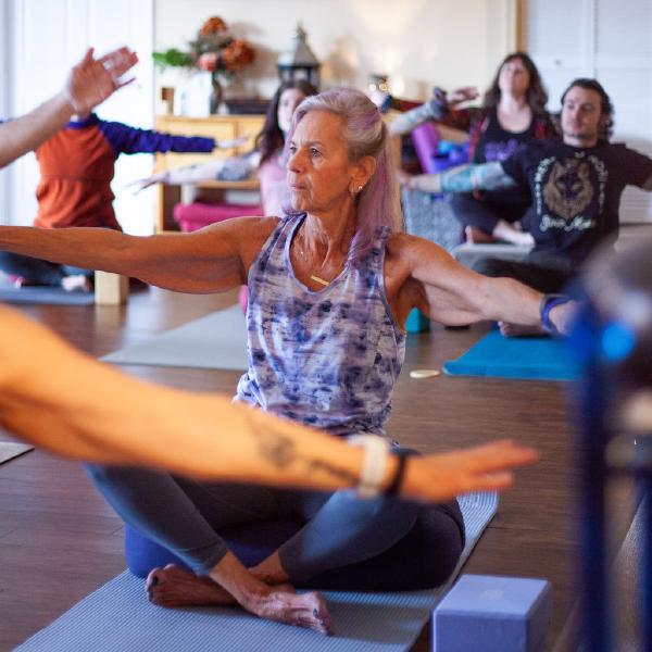 elder gentleman doing yoga on mat