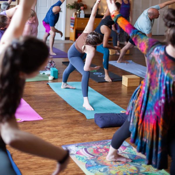 woman in lotus pose with dog