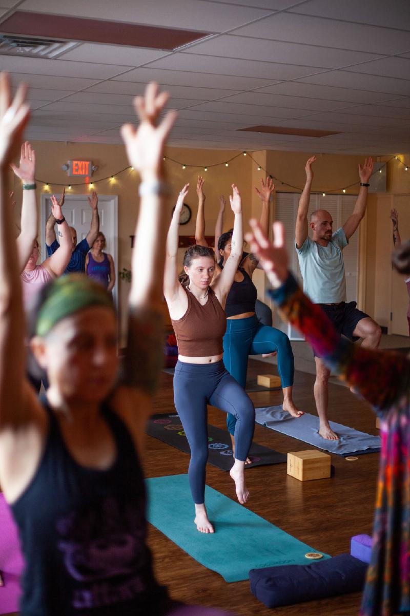 students doing yoga poses with arms up