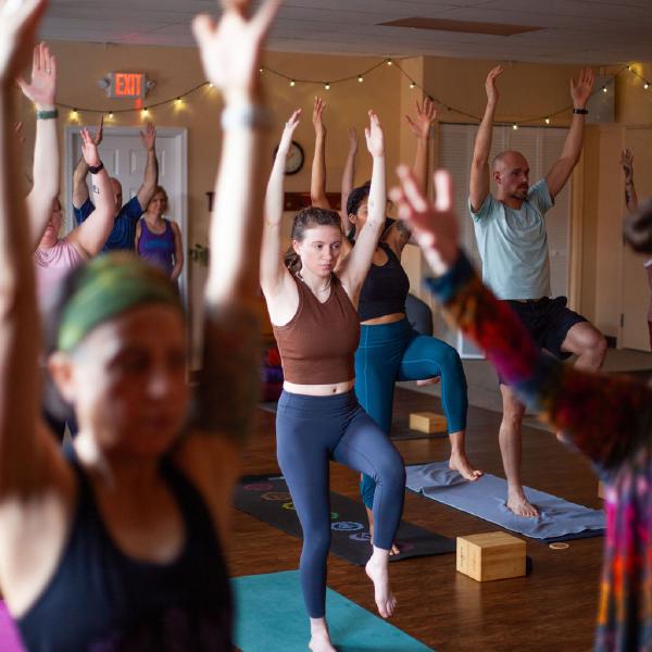 students doing yoga poses with arms up